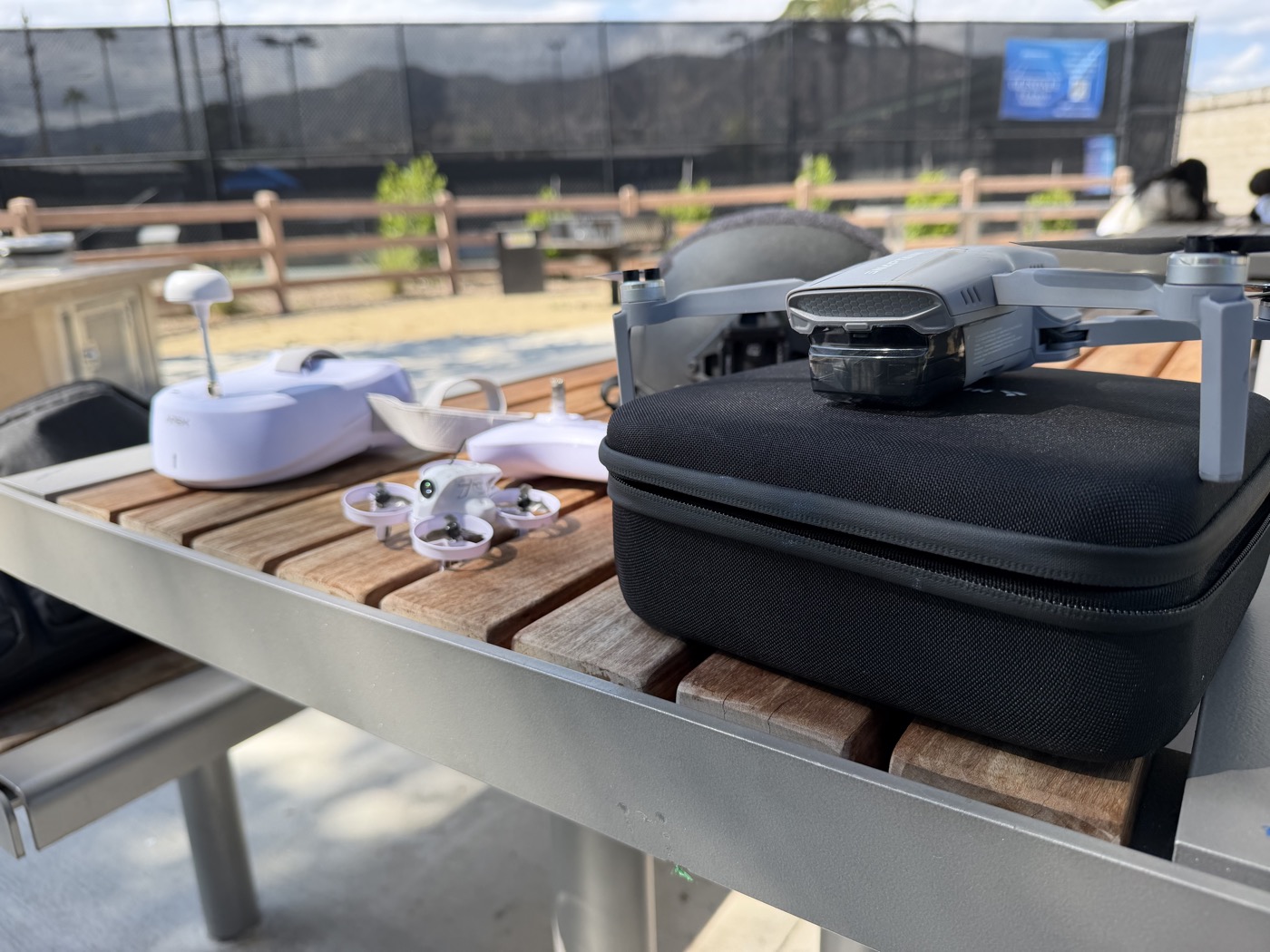 Full kit: DJI Mini drone, FPV goggles, tinywhoop, and Pelican case laid out
